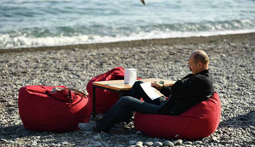 Man relaxing on the beach in Yalta