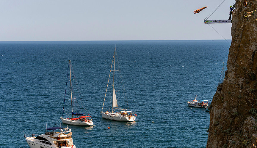 A participant of the International Cliff Diving Championship in Simeiz jumps from the Diva Cliff
